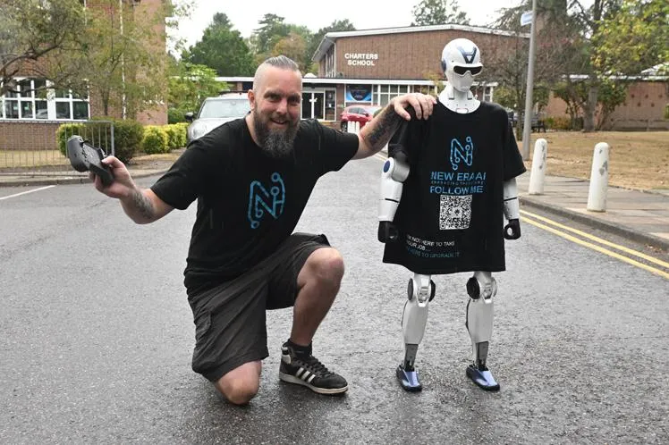 Chris Drinkwater kneeling beside Jimmy outside Charters School