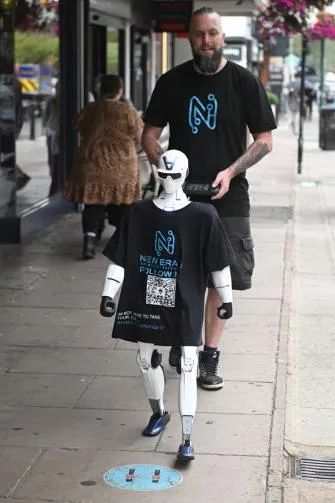 Jimmy walking along Ascot High Street in a New Era AI Follow Me shirt, with Chris Drinkwater behind him