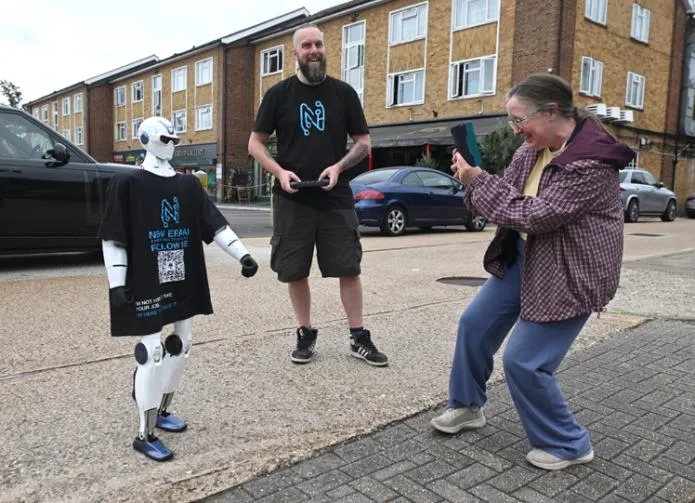 A woman taking a photo of Jimmy on an Ascot street, with Chris Drinkwater smiling beside him