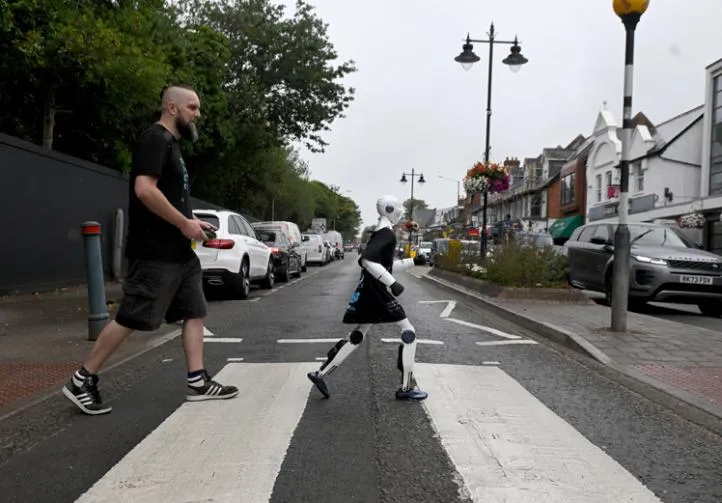 Jimmy crossing a zebra crossing in Ascot, with Chris Drinkwater walking behind him